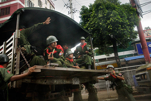 Burmese Government Soldiers sit inside a truck